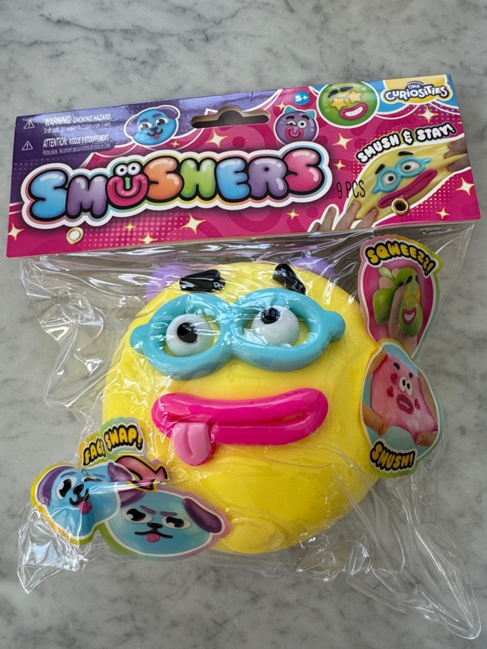 Smushers Yellow Squeezable Face Toy with Blue Mask and Pink Tongue